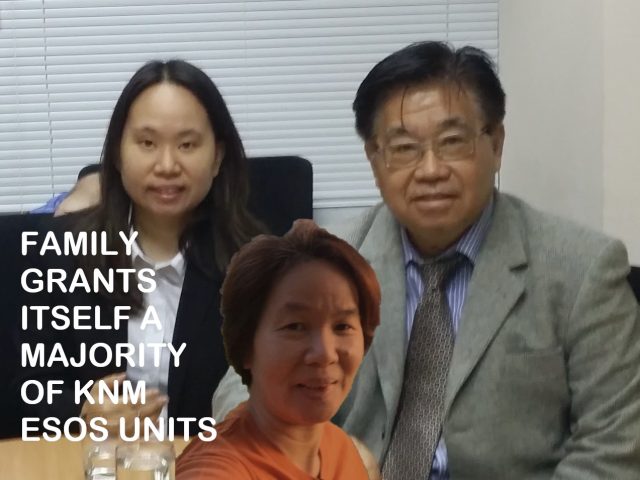 GAN SIEW LIAT FAMILY KNM ESOS A woman in a business suit reviews documents at a desk, with a company logo visible in the background.
