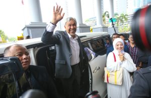 Ahmad Zahid Hamidi Wins Discharge on 47 Malaysia Graft Charges Ahmad Zahid Hamidi, flanked by lawyers, leaves court after judge grants discharge on 47 corruption charges.