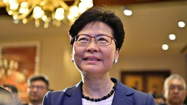 Carrie Lam Hong Kong Financial Carrie Lam speaking at an Asian Financial Forum event in Hong Kong, addressing business leaders and investors.