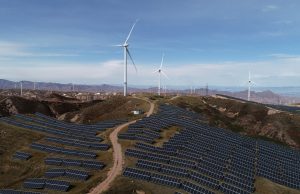 China Clean Power Capacity Surpasses Fossil Fuels Solar panels and wind turbines stretch across a Chinese landscape, symbolizing the country's growing renewable energy capacity.