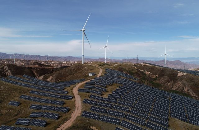 China Solar Wind Farm 2026 Solar panels and wind turbines stretch across a Chinese landscape, symbolizing the country's growing renewable energy capacity.