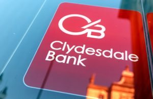 Clydesdale and Yorkshire Banks Miss Wage Payments Customers checking empty bank accounts on smartphones outside a Clydesdale Bank branch in Yorkshire