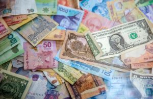 HSBC Pays $600M for Decade-Long Forex Rigging Traders huddle over Bloomberg terminals in a dimly lit dealing room as forex benchmark rates flash on screens.