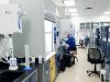 Kyntra Bio Bets All on Single Experimental Cancer Drug A scientist in a lab coat examines a vial labeled with an experimental cancer drug in a modern laboratory setting.