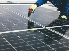 UK Solar Panels Hit Record 15,420 Megawatts Solar panels on a rooftop under a bright blue sky, generating electricity on a sunny afternoon.
