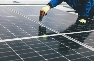 UK Solar Panels Hit Record 15,420 Megawatts Solar panels on a rooftop under a bright blue sky, generating electricity on a sunny afternoon.