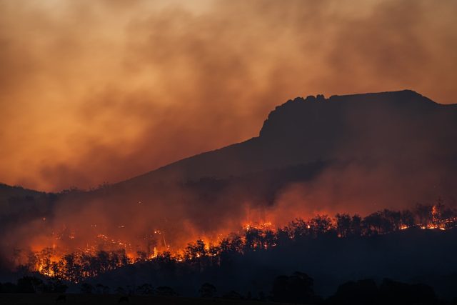 Evacuees flee to shelters as Kelowna wildfire destroys resort, threatens homes Evacuees stream into a reception center in Kelowna, carrying few belongings as smoke rises from burning neighborhoods in the background.