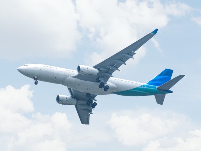 FAA Grounds All Boeing 737 Max 9 Jets After Mid-Flight Door Plug Failure A Boeing 737 Max 9 aircraft parked on a tarmac with maintenance crew inspecting the fuselage near the door plug area.