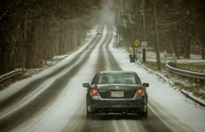 Two States Account for 89 US Winter Storm Deaths Snow-covered roads and damaged power lines in a residential area after a winter storm