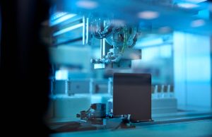 Researchers Identify Lupus Root Cause, Potential Cure Researchers in a laboratory examining a lupus model under a microscope, with medical charts in the background.