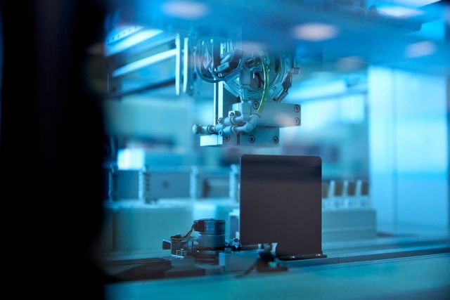 Scientists Identify Lupus Cause and Potential Cure in New Study Researchers in a laboratory examining a lupus model under a microscope, with medical charts in the background.