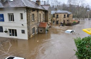 Vienna Floods Cause Extensive Economic Damage Floodwaters cover a Vienna street as residents wade through debris near damaged buildings.