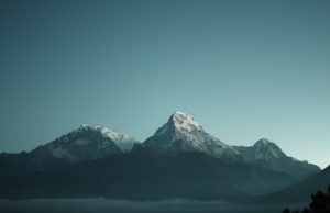 Lightning Kills Three Hikers on Austrian Mittagsspitze Three hikers ascend a rocky ridge on Mittagsspitze under dark storm clouds in the Central Eastern Alps.