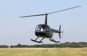 5 Ugandan Soldiers Killed in Mogadishu Helicopter Crash Wreckage of a military helicopter near an airport runway in Mogadishu, with emergency responders approaching the crash site.