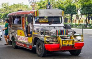 Jeepney Crash Kills 4, Injures 10 in Philippines A colorful jeepney with chrome details and hand-painted scenes on a rural road in Oriental Mindoro, Philippines.