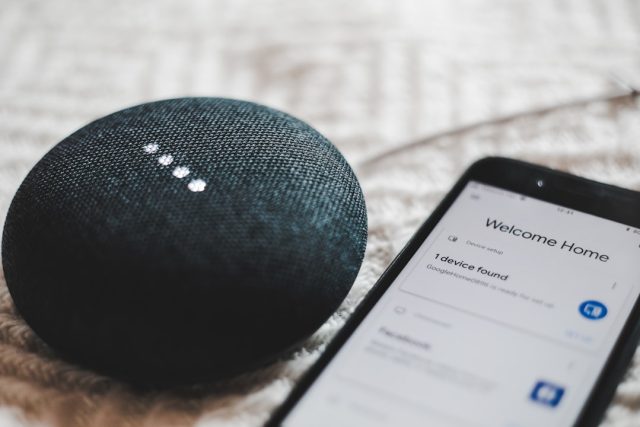 Amazon Combines Nova and Anthropic's Claude Models in Alexa+ Overhaul Amazon Echo speaker glowing blue on a table as Alexa+ processes a voice command using Nova and Claude AI models.