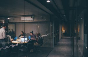 Anthropic Raises $13B in Record AI Funding Round Anthropic co-founders Daniela and Dario Amodei stand in a modern office, discussing AI safety on a screen displaying Claude's constitutional AI principles.