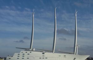 Four Bodies Recovered From Sunk Superyacht Bayesian Rescue teams search near a partially submerged superyacht in open water, with recovery boats and divers visible.