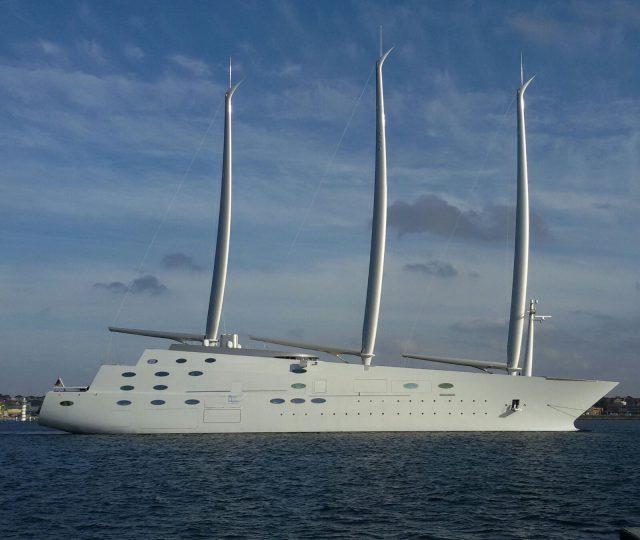 Four Bodies Recovered From Sunk Superyacht Bayesian Offshore Accident Rescue teams search near a partially submerged superyacht in open water, with recovery boats and divers visible.