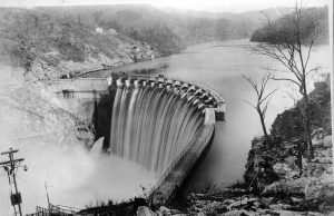 False Dam Failure Report Sparks Tennessee Evacuation Concrete arch of Walters Dam spanning the Pigeon River in the Great Smoky Mountains with autumn foliage on the banks.