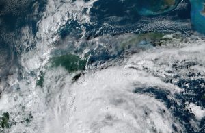 Tropical Storm Sara Hits Belize After Flooding Honduras Satellite image of Tropical Storm Sara approaching the coast of Belize with heavy cloud cover and rain bands.