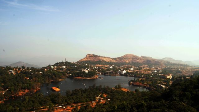 Bus Accident in Gujarat, India Leaves Seven Dead and 15 Injured A damaged bus lies at the bottom of a steep gorge near Saputara hill station, with emergency responders and debris visible around the wreckage.
