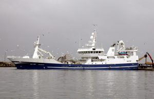 Fishing Trawler Capsizes Off Jeju, Five Missing A capsized fishing trawler floats in rough seas off Jeju Island as coast guard boats approach for rescue operations.