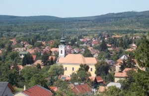 Hungary Building Fire Kills 3, Injures 22 Emergency responders work at a residential building fire in Budakeszi, Hungary, with flames and smoke rising from the structure.