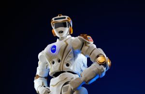 Honor Robot Beats Human Half Marathon Record A humanoid robot running on a Beijing race course, crossing a finish line with spectators watching.
