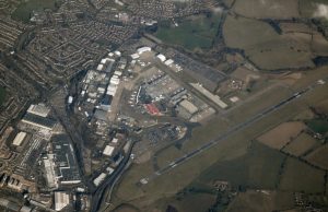 Car Park Fire Halts All Flights at Luton Airport Firefighters battling a blaze in a multistorey car park at London Luton Airport, with smoke rising above the terminal building.