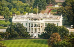 Trump Orders US Withdrawal from World Health Organization President Donald Trump signing an executive order at a desk surrounded by officials in the White House.