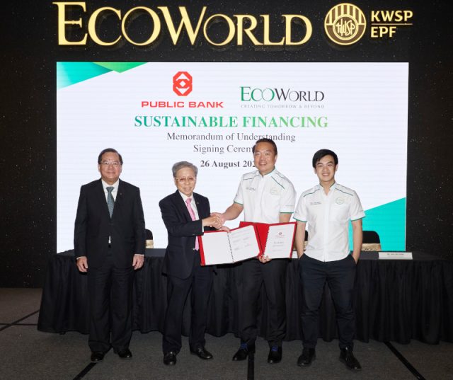 Ecoworld Public Bank Green Property Financing EcoWorld and Public Bank representatives shaking hands at a signing ceremony for a green financing MoU at Eco Grandeur township.