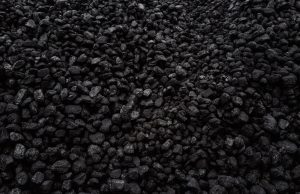 EU Bans Russian Coal, Costs Moscow €4B Yearly European Union officials signing documents on a coal embargo against Russia, with charts showing energy trade figures in the background.