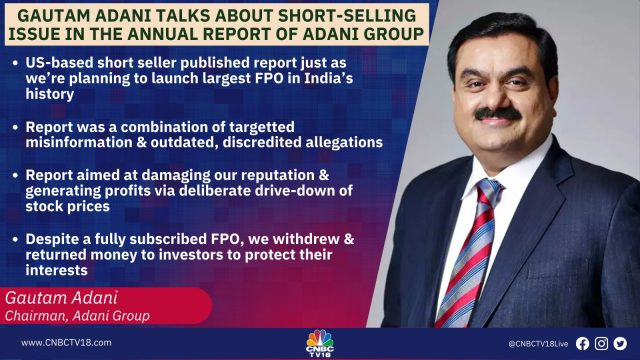 Gautam Adani Hindenburg Report Ports Gautam Adani speaking at a business conference, with the Adani Group logo displayed behind him.