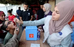 Gaza Polio Epidemic Threatens Global Eradication A child receives a polio vaccine drop in a Gaza clinic amid the 2024 outbreak.