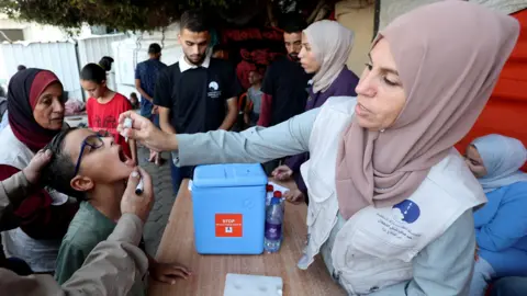 Gaza 2024 Polio Outbreak A child receives a polio vaccine drop in a Gaza clinic amid the 2024 outbreak.