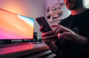 Google Lens Neural Tool Reaches Millions Since 2017 Person aims phone camera at a flower while Google Lens overlay displays plant name and facts on screen.