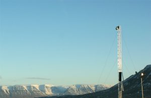 Iceland Warns of Imminent Fagradalsfjall Eruption Seismic monitoring equipment on a volcanic landscape near Reykjavík, with steam rising from Fagradalsfjall in the background.