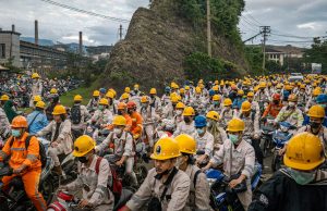 Indonesia Nickel Mining Sparks Land Rights Protests Protesters gather near a nickel mining site in Indonesia, holding signs against land encroachment and displacement.