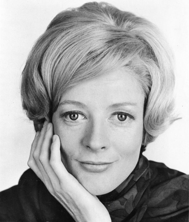 Maggie Smith Dame Maggie Smith smiling in a theatrical costume on stage during a performance