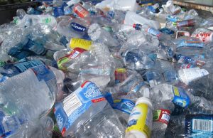 Malaysia Tops Asian Plastic Waste at 16.8 kg Per Capita A pile of discarded plastic packaging and containers on a polluted beach near Kuala Lumpur, with waves washing debris ashore.