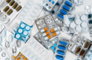Mirati Wins FDA OK for KRAS Lung Cancer Pill Krazati Close-up of hands opening a bottle labeled Krazati, the new oral KRAS G12C inhibitor for lung cancer patients.