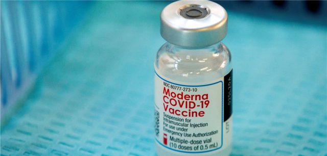 Moderna Mrna 1273 Niaid Vaccine Shipment A scientist in a lab coat holds a vial labeled mRNA-1273, the Moderna coronavirus vaccine, ready for shipment to NIAID for clinical testing.