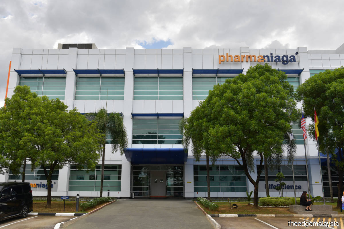 Pharmaniaga Supplies Sinovac to State Govts, Private Firms Pharmaniaga workers handling Sinovac vaccine vials at a Puchong facility for state and private distribution.