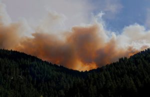 Quebec Wildfires Force 10,000 From Sept-Îles Homes Aerial view of wildfire smoke billowing over Sept-Îles, Quebec, as residents evacuate along a highway.