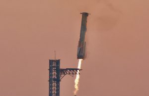 SpaceX Catches Super Heavy Booster at Launch Tower SpaceX Super Heavy Booster 12 caught by chopstick arms at the launch tower during Starship flight test 5