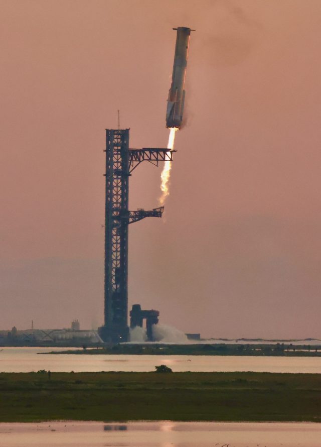 Starship flight test 5 SpaceX Super Heavy Booster 12 caught by chopstick arms at the launch tower during Starship flight test 5