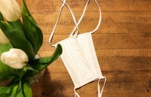 Study Confirms Cloth Masks Block 99% of Aerosols A person wearing a multi-layer cloth mask in a public setting, demonstrating proper mask fit and fabric coverage.
