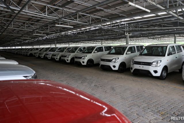Taiwan Car Sales Increase Coronavirus A row of new Toyota Corolla crossovers at a dealership in Taiwan, with a salesperson showing a car to a customer.