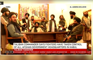 Facebook Bans Taliban as Social Media Firms Face Challenge Facebook logo displayed on a smartphone screen with a blurred background of news headlines about Afghanistan.